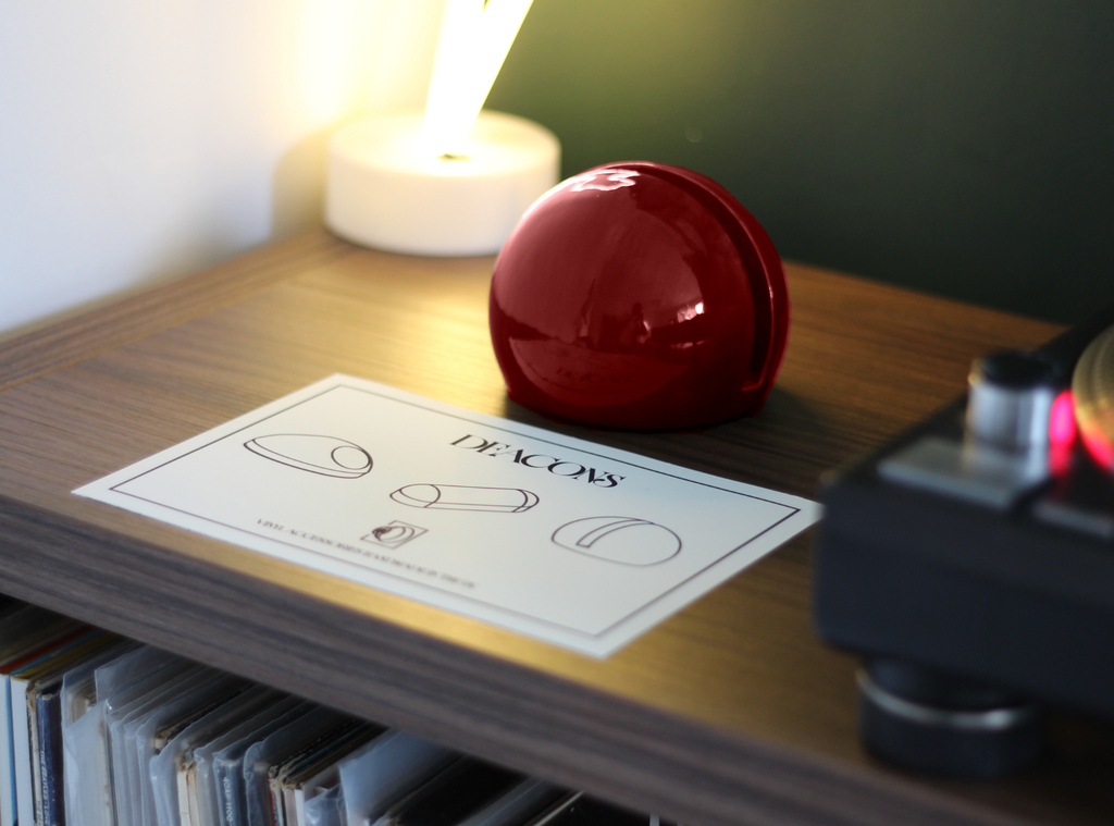 CHERRY RED PODD VINYL HOLDER ON TABLE WITH RECORD PLAYER